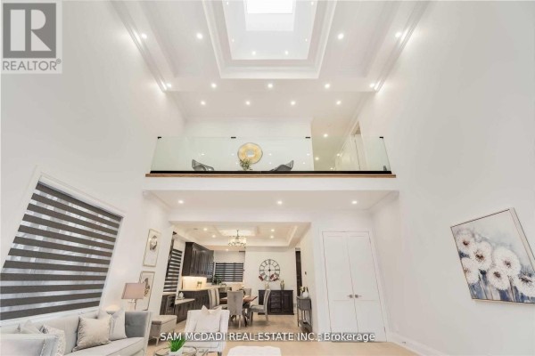 Living room with skylight, glass railing balcony, and open concept view to kitchen - 1138 Garden Road Mississauga