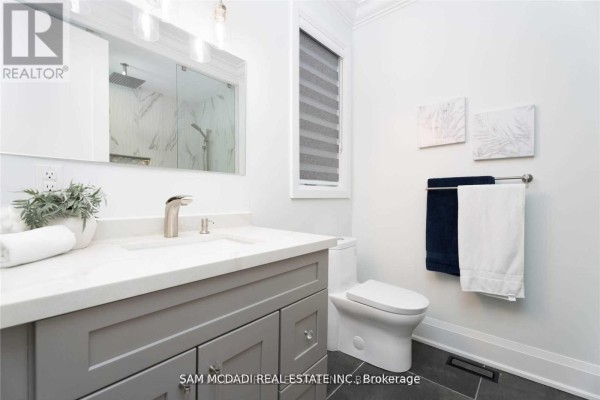 Modern bathroom with double vanity, marble shower, and sleek fixtures - 1138 Garden Road Mississauga