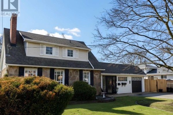 A view of the house from the left, showing the stone facade and attached garage. - 114 Colborne Street W, Kawartha Lakes