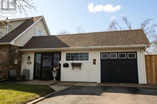 Close-up of the house entrance and garage door with a bright blue sky overhead. - 114 Colborne Street W, Kawartha Lakes