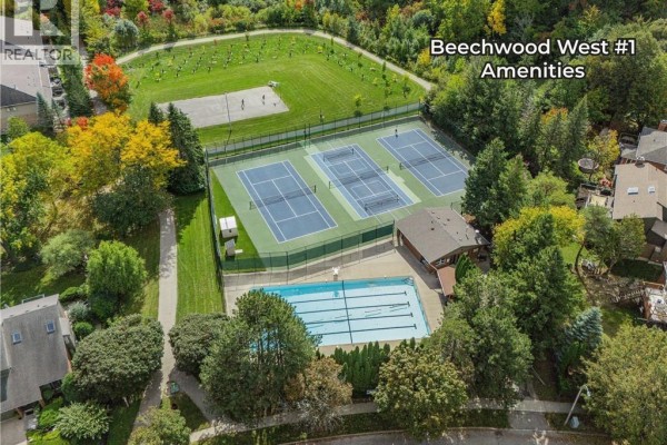Aerial view of Beechwood West #1 amenities featuring tennis courts and a swimming pool. - 114 Frederick Banting Place, Waterloo