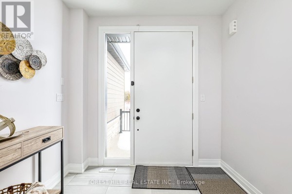 Interior entryway with a white front door, adjacent window, light grey walls, and a console table. - 114 Goldie Court, Blue Mountains