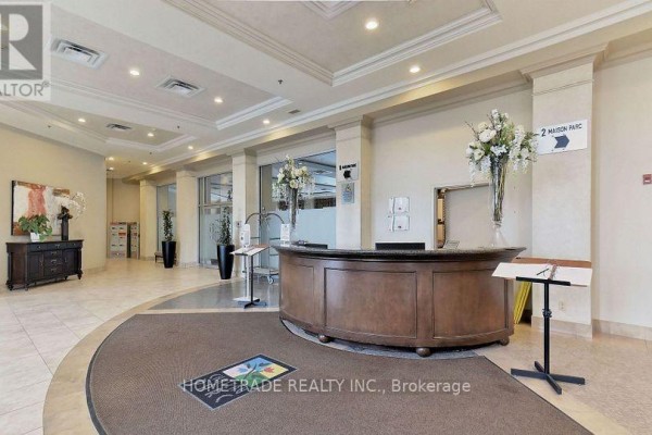 Building lobby with a reception desk, seating area, and artwork. - 115 - 2 Maison Parc Court, Vaughan