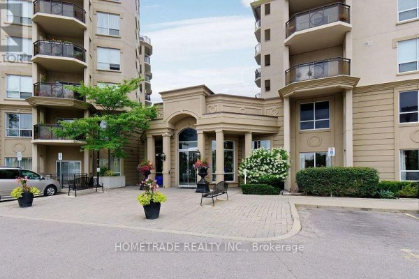 Exterior of an apartment building showing the main entrance and landscaping. - 115 - 2 Maison Parc Court, Vaughan