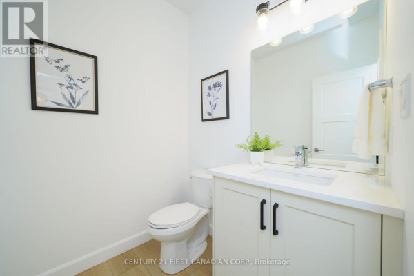 Powder room with white cabinetry, modern sink, and framed botanical art - 115 Atkinson Street, North Middlesex