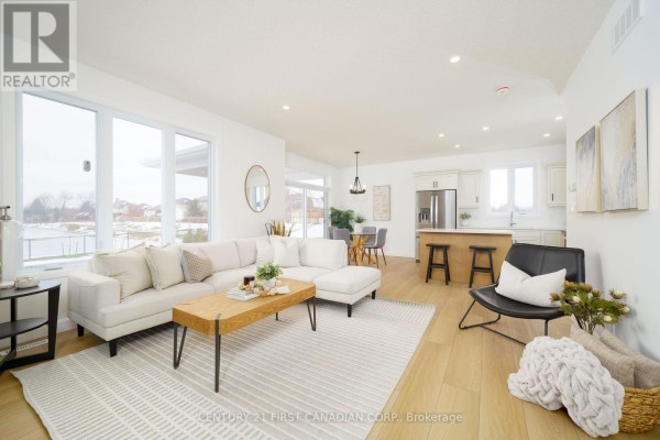 Spacious living room with large windows, modern furniture, and open kitchen layout - 115 Atkinson Street, North Middlesex