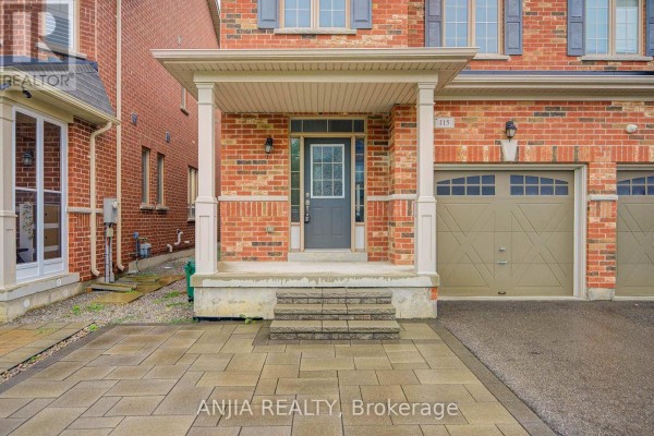 Entrance porch of a brick house with a grey door, glass panels, and stone steps. - 115 Wilfred Murison Avenue, Markham