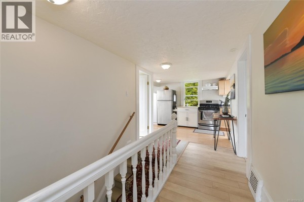 Hallway with staircase, leading to the kitchen area. - 1150 Dallas Rd, Victoria