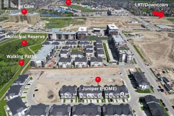 Close-up of townhouse exterior with garage and balcony, snow on the ground - 116, 2231 81st Street Sw, Calgary