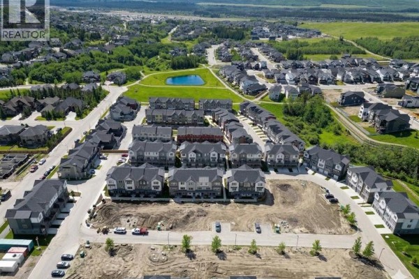 Aerial view of the neighborhood showing walking paths and surrounding homes, snow-covered landscape - 116, 2231 81st Street Sw, Calgary
