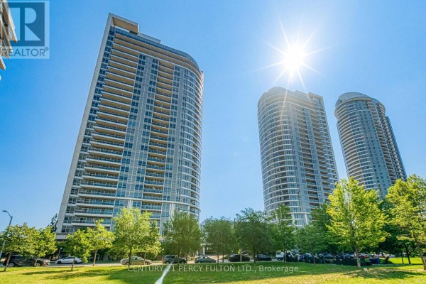 View of the apartment building and neighboring buildings with a bright sun. - 116 - 181 Village Green Square, Toronto