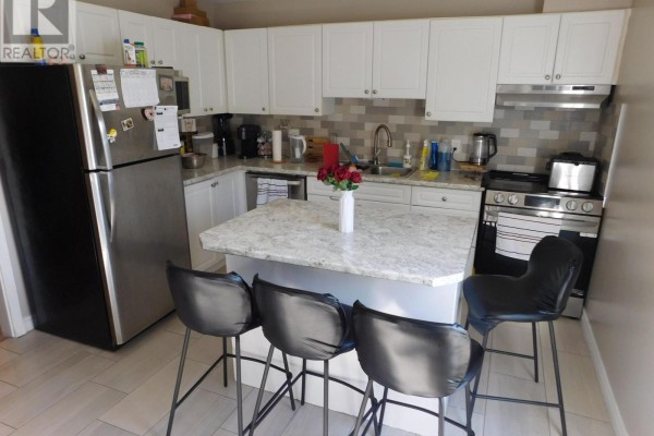 Kitchen with white cabinets, granite countertops, a stainless steel refrigerator, and island. - 116 - 70 Fiddlers Green Road, London North