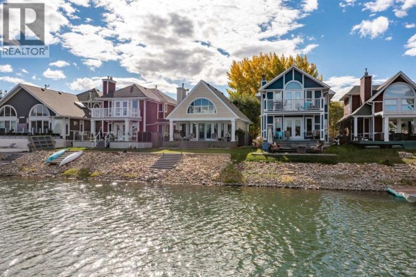 Row of waterfront homes with balconies, decks, and lake views. - 116 Marina Bay Court, Sylvan Lake