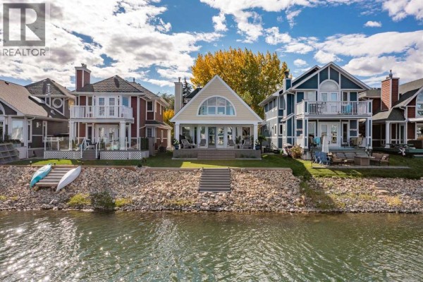 Waterfront homes with rocky shorelines and colorful autumn foliage. - 116 Marina Bay Court, Sylvan Lake