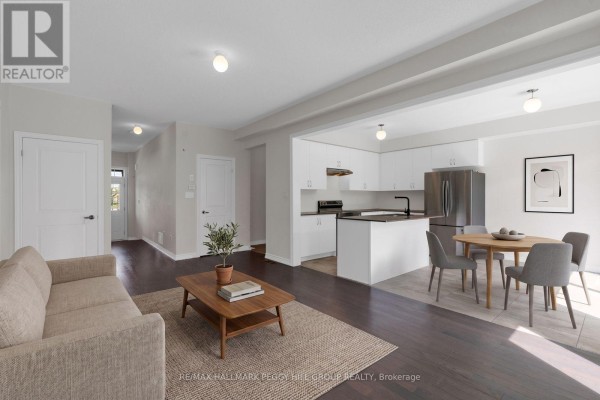 Open concept living room and kitchen area with dark wood floors. - 116 Nottingham Road, Barrie