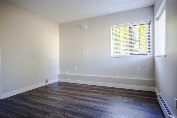 Modern bathroom with a white vanity, large mirror, and walk-in shower - 11604 75a Avenue, Delta