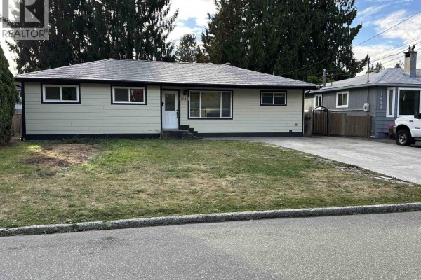 Front exterior of the house showing the lawn and the entrance steps. - 11645 Steeves Street, Maple Ridge