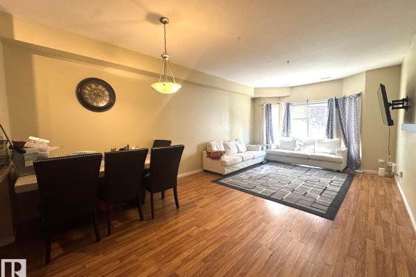 Kitchen with wood cabinets, granite countertops, stainless steel appliances, and tile flooring. - #117 4304 139 Av Nw, Edmonton
