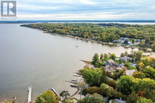 Aerial view of waterfront homes and a large lake with distant tree-lined shores. - 117 Juneau Road, Tay