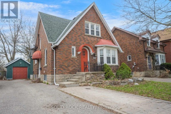 Side view of the house showing brick exterior and snow - 117 Mill Street S, Brampton
