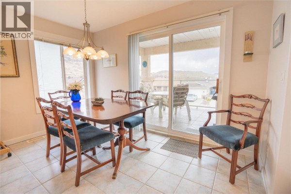 Cozy sitting area with a fireplace, beige walls, and decorative accents - 11714 Quail Ridge Place, Osoyoos