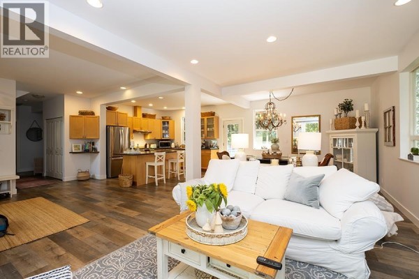 Open concept living, dining, and kitchen area with natural light. - 1172 Cedar Grove Road, Roberts Creek