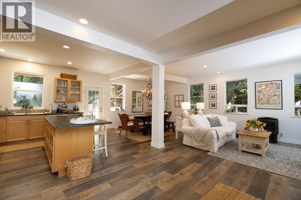 View of open concept living, dining, and kitchen with island. - 1172 Cedar Grove Road, Roberts Creek