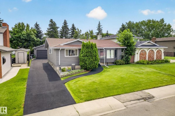 Aerial view of a grey bungalow with a driveway, garage, and lush green lawn. - 11727 27 Av Nw, Edmonton