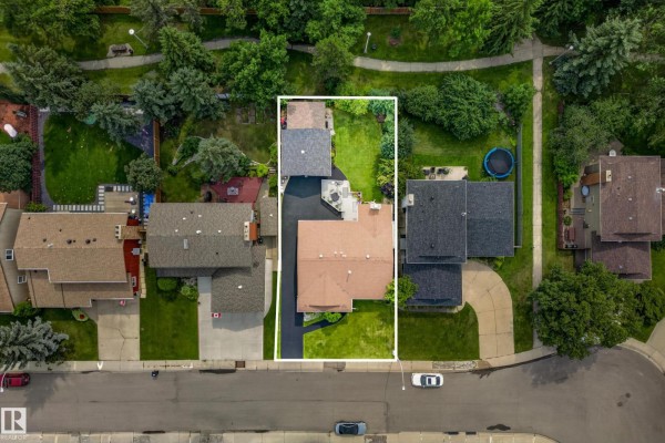 Overhead drone view of a rectangular property lot with a bungalow, garage, and backyard. - 11727 27 Av Nw, Edmonton