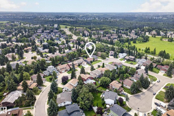 Aerial view of a suburban neighborhood with many houses and mature trees. - 11727 27 Av Nw, Edmonton