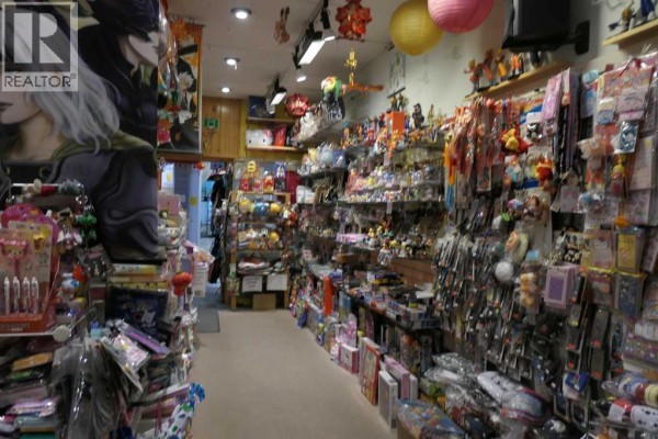 Retail store interior with shelves packed with anime figures, plush toys, and novelty items. - 118, 328 Centre Street Se, Calgary