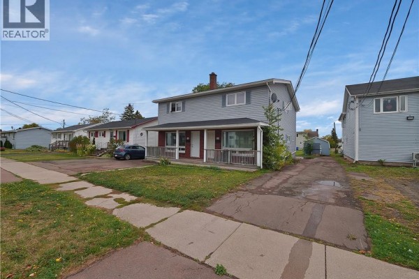 View of the multi-family home from the sidewalk, showing two units. - 118-120 Vail Street, Moncton