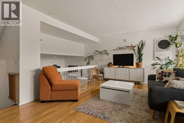 Bright kitchen featuring white cabinets, stainless steel appliances, and a chalkboard wall. - 118 Brae Glen Lane Sw, Calgary