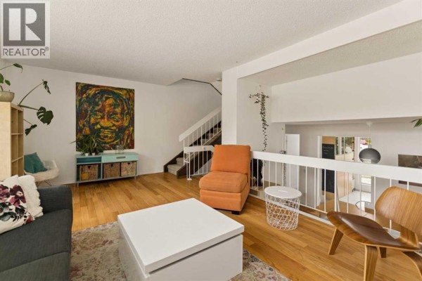 Modern kitchen with large window, open shelving, and view of outdoor patio area. - 118 Brae Glen Lane Sw, Calgary