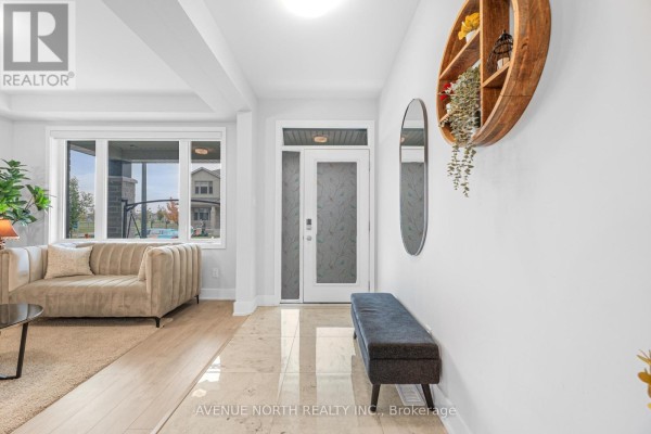 Bright entryway with a beige sofa, a dark bench, tiled floor, and frosted glass double doors. - 118 Green Ash Avenue, Ottawa