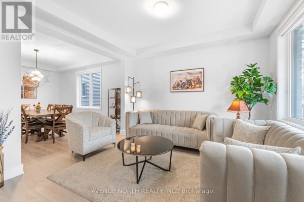 Living room with seating and a dining area with a wooden table and chairs in the background. - 118 Green Ash Avenue, Ottawa