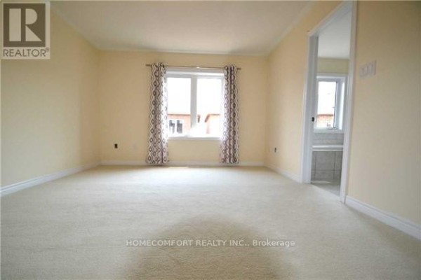 Carpeted bedroom with a window featuring patterned curtains and an ensuite bathroom. - 118 Orchardcroft Road, Oakville