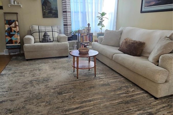 Living room with beige sofas, a wooden coffee table, and large window - 118 Second Street W, Carnduff