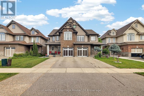 Entrance foyer with grey walls, carpeted stairs, and a tiled floor. - 1180 Caen Avenue, Woodstock