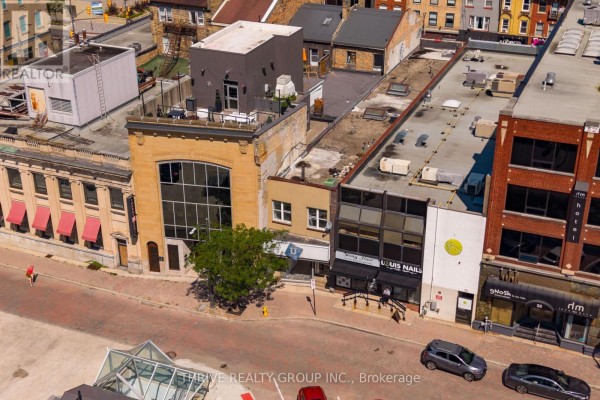 Close-up aerial view of commercial storefronts on a brick street in London East. - 119 Dundas Street, London East