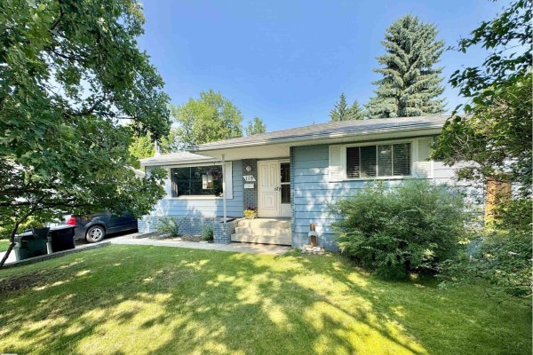 Front exterior of a light blue house with a white front door and windows. - 119 Garland Cr, Sherwood Park