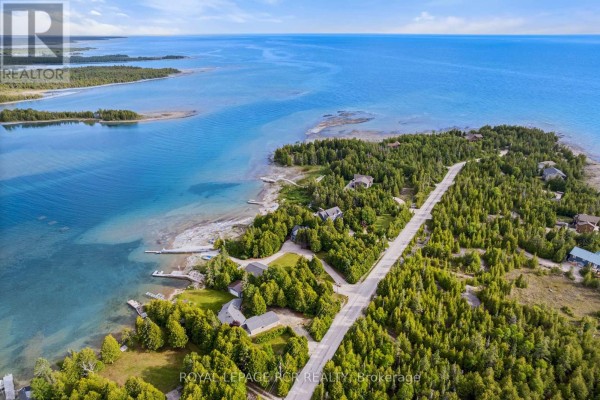 Detached garage with a metal roof, grassy area, and water view. - 119 Pine Tree Harbour Road, Northern Bruce Peninsula