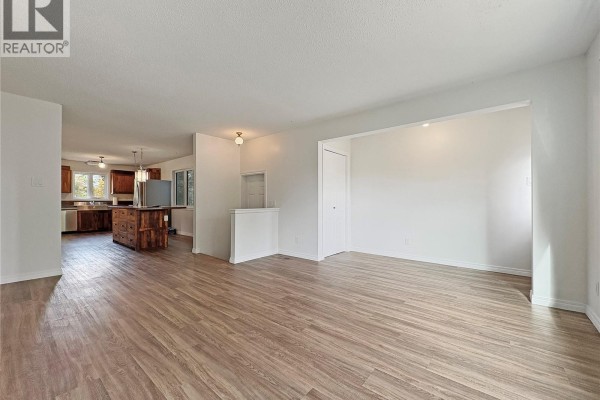 Interior entryway with burgundy walls, a white door with decorative glass, and cream-colored storage furniture. - 119 Prairie Street, Dalmeny