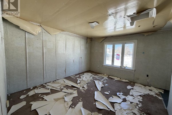 Empty room with peeling wallpaper, carpet debris, and a window - 119 South Street, Donkin