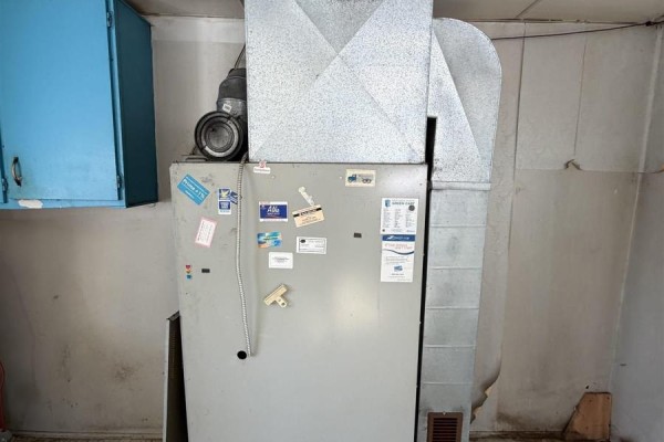 Kitchen area featuring blue cabinets, a water heater, and patterned wallpaper - 119 South Street, Donkin