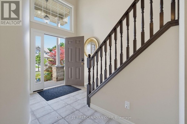 View from the entryway looking out the open front door to the front yard and street. - 1197 Smither Road, London North
