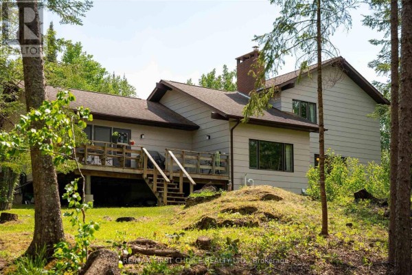 Aerial view highlighting the front of the house with a driveway and surrounding trees. - 11a Lebrons Road, Sioux Narrows Nestor Falls