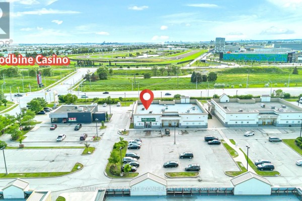 Aerial view of commercial buildings near the Woodbine Casino with a red marker. - 12 - 120 Queen Plate Drive, Toronto