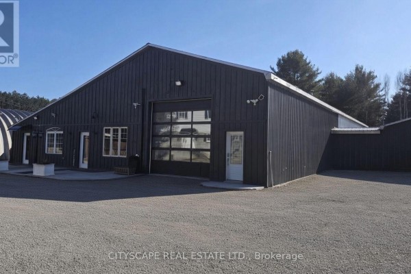 Wide view of the dark grey metal-clad commercial building exterior. - 12 - 8021 35 Highway, Kawartha Lakes