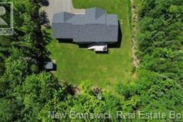 Front exterior of the house with a driveway, garage, and snow-dusted landscape. - 12 Barbara Drive, Rusagonis Waasis